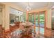 Bright dining area with hardwood floors, slider access to deck, and view of the living room at 3707 Stonegate Dr, Chapel Hill, NC 27516