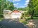 Charming home featuring a two-car garage, stone accents, and a well-manicured lawn with mature trees at 3707 Stonegate Dr, Chapel Hill, NC 27516