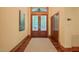 Elegant foyer featuring a striking wooden door with glass panels, hardwood floors, and neutral wall color, creating a warm welcome at 3707 Stonegate Dr, Chapel Hill, NC 27516