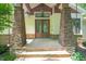 Close-up of the home's front entrance, showcasing stone pillars, a wood-framed door, and flagstone steps, emphasizing curb appeal at 3707 Stonegate Dr, Chapel Hill, NC 27516