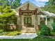 Inviting front entrance with stone pillars, a stylish wood door, and manicured landscaping, offering a warm and welcoming appeal at 3707 Stonegate Dr, Chapel Hill, NC 27516