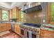 Gourmet kitchen with granite countertops, stainless hood, and chef's gas range at 3707 Stonegate Dr, Chapel Hill, NC 27516