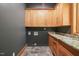 Efficient laundry room with ample cabinet space and counter space for folding and sorting laundry at 3707 Stonegate Dr, Chapel Hill, NC 27516