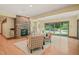 Cozy living room features a stone fireplace, with natural light from sliding glass doors to outdoor space at 3707 Stonegate Dr, Chapel Hill, NC 27516