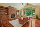 Inviting living room with stone fireplace, hardwood floors, and picturesque window views at 3707 Stonegate Dr, Chapel Hill, NC 27516