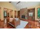 Spacious living room with a stone fireplace, built-in shelves, hardwood floors, and neutral walls, perfect for relaxation and entertainment at 3707 Stonegate Dr, Chapel Hill, NC 27516