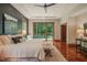 Luxurious main bedroom with trey ceiling, balcony, and dark green accent wall with art at 3707 Stonegate Dr, Chapel Hill, NC 27516