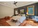 Serene main bedroom with modern lighting, and dark accent wall with views of mature trees outside at 3707 Stonegate Dr, Chapel Hill, NC 27516