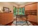 Bright office with large windows, built-in cabinets, and custom desk provides a dedicated workspace at 3707 Stonegate Dr, Chapel Hill, NC 27516