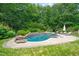 Inviting in-ground pool surrounded by lush greenery and lounge chairs at 3707 Stonegate Dr, Chapel Hill, NC 27516