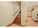 Elegant wooden staircase with paneled walls featuring ambient lighting for a warm, inviting atmosphere at 3707 Stonegate Dr, Chapel Hill, NC 27516