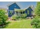 Lush backyard with green grass, a patio, and a view of the home's exterior and landscaping at 41 Highveld Ave, Chapel Hill, NC 27516