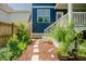 Landscaped backyard with stone walkway and verdant plants leading to the house's blue siding at 41 Highveld Ave, Chapel Hill, NC 27516