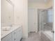 Bright bathroom features a double sink vanity, a large mirror, and a glass shower at 41 Highveld Ave, Chapel Hill, NC 27516