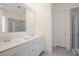 Bright bathroom features a double sink vanity, a large mirror and a glass shower at 41 Highveld Ave, Chapel Hill, NC 27516