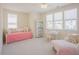 Bright bedroom features daybed and chaise lounge with white desk, shelves, and large windows at 41 Highveld Ave, Chapel Hill, NC 27516