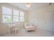 Bright bedroom with large windows, daybed, chaise lounge, white desk, and closet at 41 Highveld Ave, Chapel Hill, NC 27516