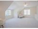 Spacious bonus room with plush carpet, natural light, and a cozy reading nook at 41 Highveld Ave, Chapel Hill, NC 27516