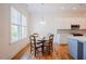 Cozy dining area with hardwood floors, a charming table set, and bright natural light streaming through the windows at 41 Highveld Ave, Chapel Hill, NC 27516