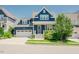Charming navy blue home featuring a two-car garage and beautifully landscaped front yard at 41 Highveld Ave, Chapel Hill, NC 27516