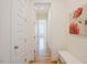 Bright hallway featuring hardwood floors, white trim, and doors creating a clean, welcoming passageway at 41 Highveld Ave, Chapel Hill, NC 27516