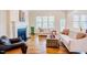 Inviting living room with fireplace, comfortable sofas, hardwood floors, and ample natural light from large windows at 41 Highveld Ave, Chapel Hill, NC 27516
