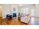 Bright living room featuring hardwood floors, a fireplace, and comfortable seating with an abundance of natural light at 41 Highveld Ave, Chapel Hill, NC 27516