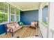 Inviting covered porch with wooden flooring and blue siding featuring comfortable seating at 41 Highveld Ave, Chapel Hill, NC 27516