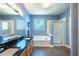 Bright bathroom with double sinks, soaking tub, and glass-enclosed shower at 413 Great Smokey Mountain Dr, Mebane, NC 27302