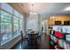 This dining area features dark wood floors, bright natural light, and direct access to an outdoor patio at 413 Great Smokey Mountain Dr, Mebane, NC 27302
