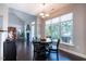 Bright dining area with a large window and dark wood floors offers a cozy eating space and natural light at 413 Great Smokey Mountain Dr, Mebane, NC 27302