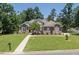 Beautiful single-Gathering home with a well-manicured lawn, mature trees, and a traditional architectural style at 413 Great Smokey Mountain Dr, Mebane, NC 27302