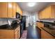 Spacious kitchen with ample cabinet space and dark hardwood floors at 413 Great Smokey Mountain Dr, Mebane, NC 27302