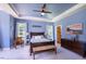 Serene main bedroom featuring a tray ceiling, soft blue walls, and a ceiling fan, offering a peaceful retreat at 413 Great Smokey Mountain Dr, Mebane, NC 27302