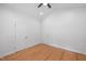 Bright bedroom with hardwood floors, ceiling fan, and fresh white walls at 4217 Us-70, Durham, NC 27705
