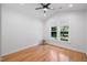 Cozy bedroom featuring hardwood floors, a ceiling fan and view from the window at 4217 Us-70, Durham, NC 27705