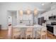 Modern kitchen featuring white cabinets, stainless steel appliances, and a large center island with seating at 4217 Us-70, Durham, NC 27705