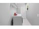 Efficient laundry room with washer and dryer, storage shelf and access to backyard at 4217 Us-70, Durham, NC 27705