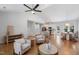 Open-concept living area with hardwood floors, a modern ceiling fan, and seamless flow to kitchen and dining space at 4217 Us-70, Durham, NC 27705