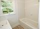 Bathroom with shower-tub combination and large window looking into the yard at 4414 Nc Hwy 87 N, Pittsboro, NC 27312