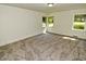 This bedroom has new neutral carpet and windows that let in natural light at 4414 Nc Hwy 87 N, Pittsboro, NC 27312
