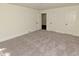 A spacious bedroom features neutral carpet and white trim with three closets at 4414 Nc Hwy 87 N, Pittsboro, NC 27312