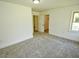 This bedroom has carpet, a large closet, and a window to the outside at 4414 Nc Hwy 87 N, Pittsboro, NC 27312