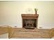 Rustic brick fireplace with a wood-burning stove and decorative mantle at 4414 Nc Hwy 87 N, Pittsboro, NC 27312