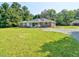 Beautiful ranch with a large front yard and gravel driveway to a detached garage at 4414 Nc Hwy 87 N, Pittsboro, NC 27312