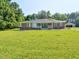 Charming brick ranch with a blue front door and a spacious front yard at 4414 Nc Hwy 87 N, Pittsboro, NC 27312