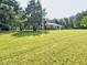 Well-maintained lawn and mature trees surround this traditional brick home, creating a private and serene setting at 4414 Nc Hwy 87 N, Pittsboro, NC 27312