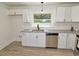 Bright kitchen with new stainless appliances, white cabinets, and granite counters at 4414 Nc Hwy 87 N, Pittsboro, NC 27312