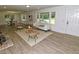 Bright living room with wood floors, neutral colors, and a view of the front yard at 4414 Nc Hwy 87 N, Pittsboro, NC 27312
