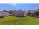 View of a grassy backyard featuring a home with gray siding and a sliding glass door to the patio at 4928 Silverdene St, Raleigh, NC 27616